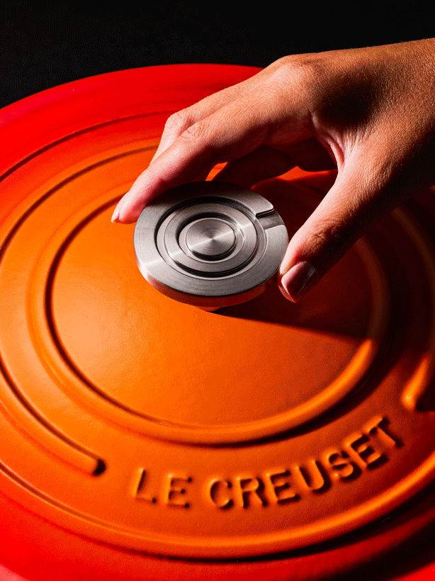 Cookware on the heat, hands stirring, steam rising