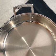 A cook mid-technique, searing or deglazing